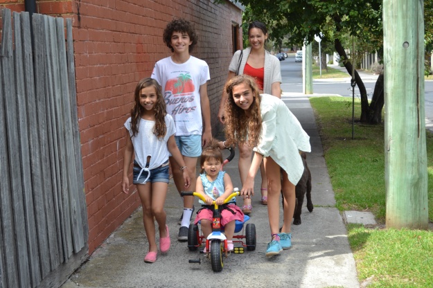 The family walking to the park with new TOMS shoes, a $5 trike and a second-had cricket bat to play on Christmas morning
